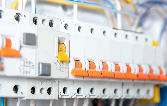 Row of modern circuit breakers that require protection with flame retardants to be fire safe.