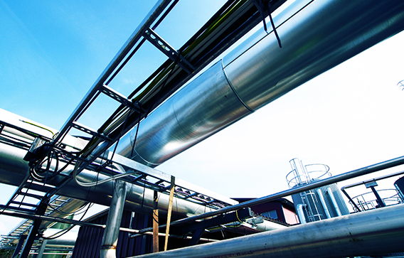 Large steel pipes running across production plant illustrate many industrial uses of Clariant’s phosphorus chemicals.