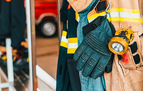 Protective wear hanging in fire station illustrates the importance of Clariant’s flame retardants for firefighter safety.