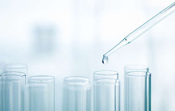 Clariant_A close-up of a laboratory glass pipette with emerging drop of substance