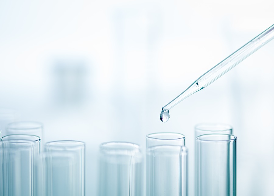 This image shows a close-up of a laboratory setting with several transparent test tubes and a pipette releasing a droplet of liquid into one of the test tubes. The background is blurred, emphasizing the focus on the pipette and test tubes. This setup is commonly used in scientific experiments, chemical analysis, or medical testing. If you need more specific information or have questions about laboratory procedures, feel free to ask!