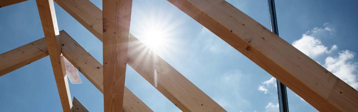 Wooden construction in bird's eye view with blue sky and sun