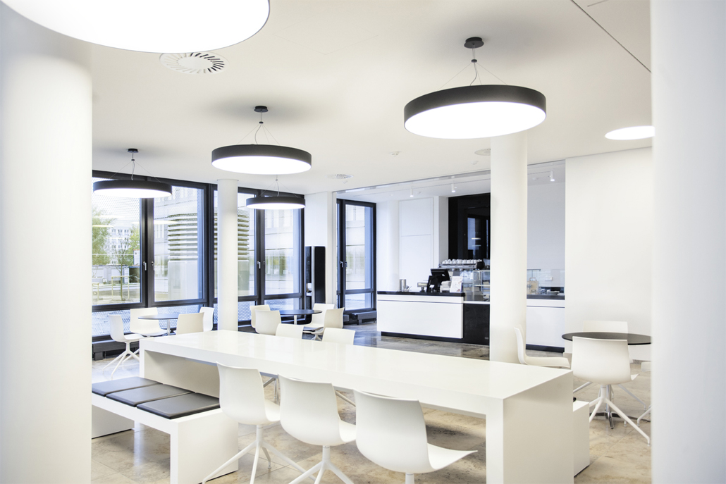  The large communal table invites visitors and employees to chat over coffee and cake.