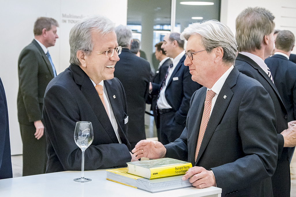  Chief Executive Officer Dr. Hariolf Kottmann talking with guests at the opening event.