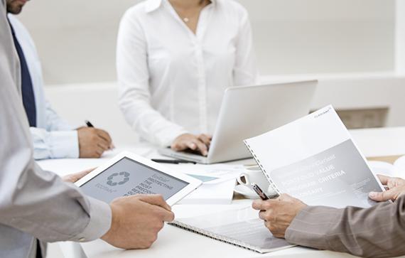 Meeting of employees working with laptops and documents